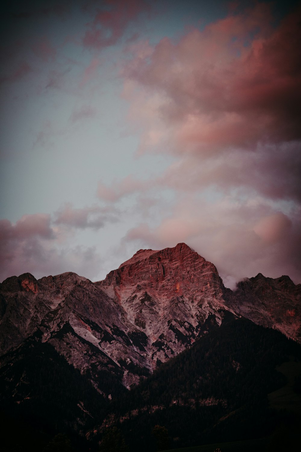 a mountain with a pink sky in the background