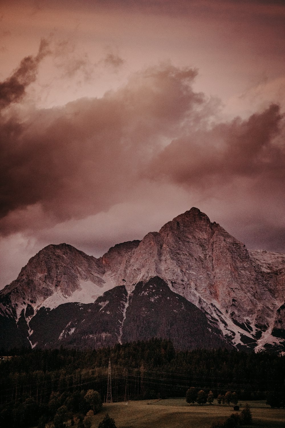 a mountain range under a cloudy sky