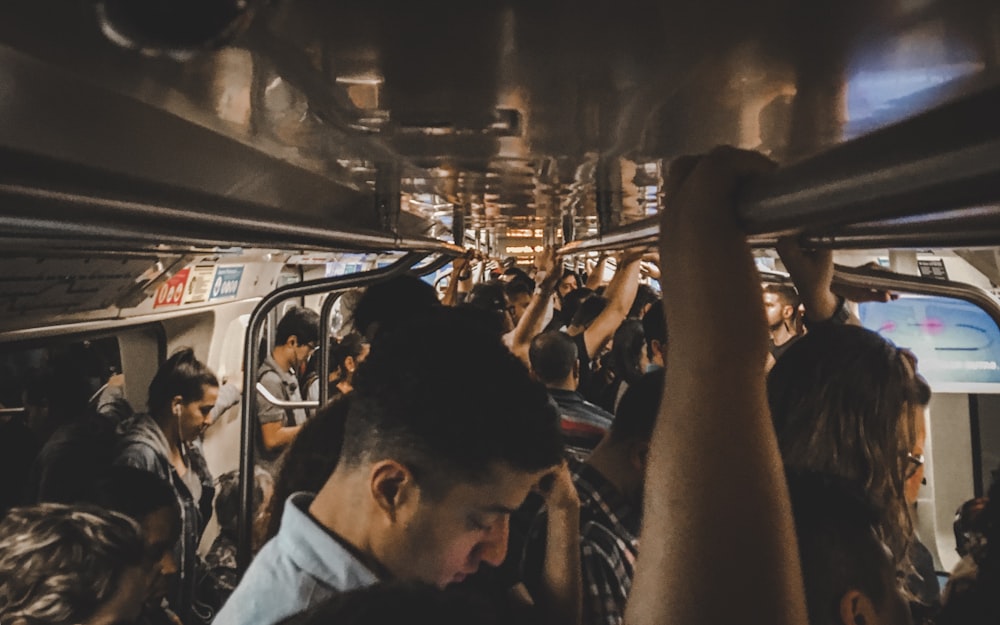 a group of people riding on a subway train