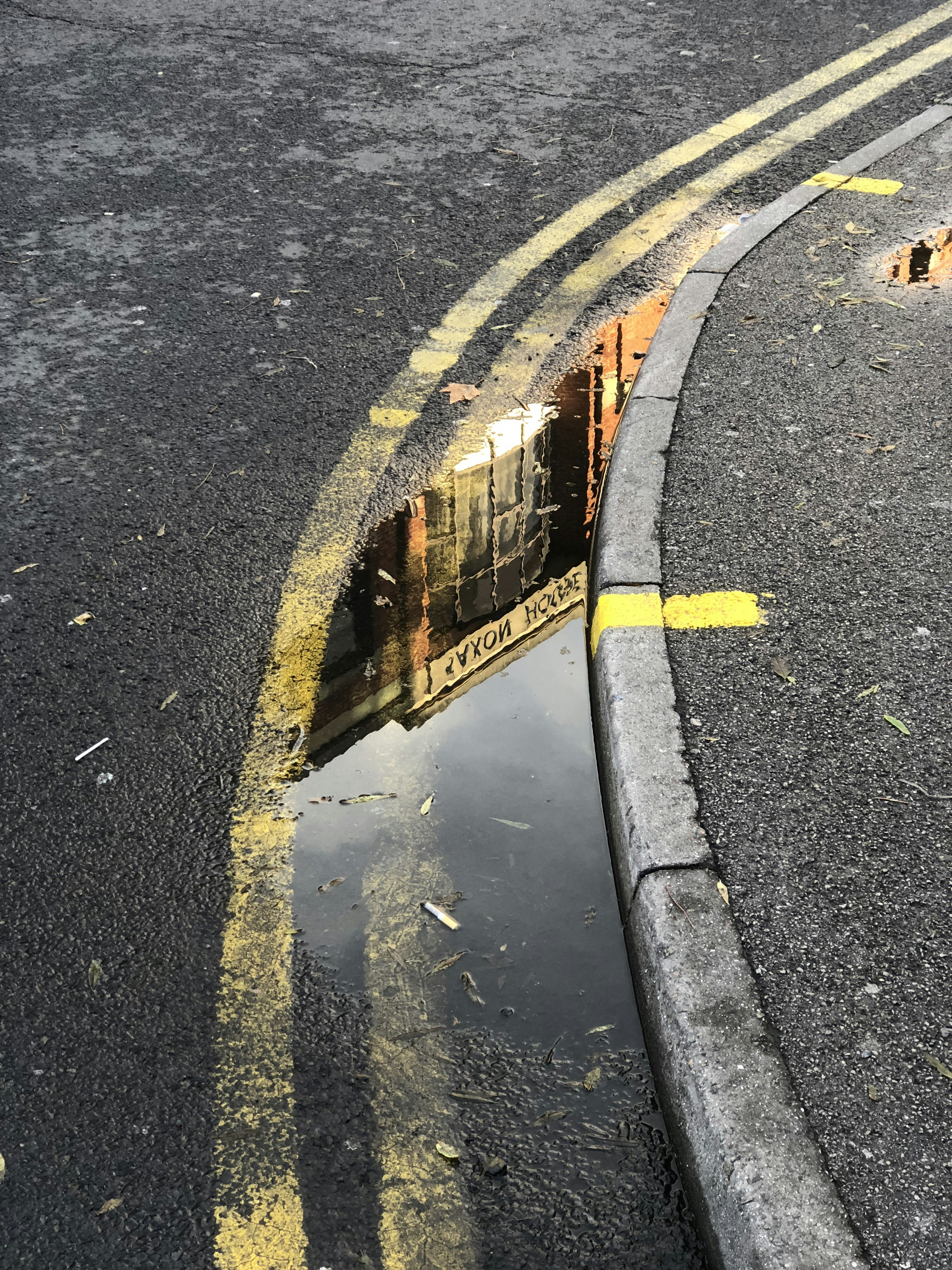 a reflection of a train in a puddle of water