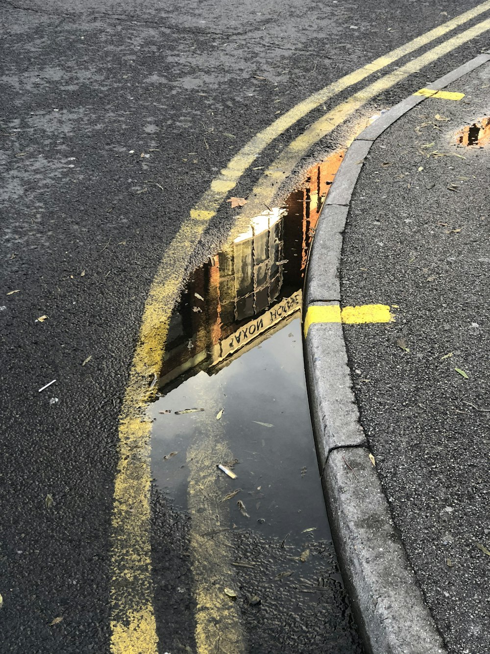 a reflection of a train in a puddle of water