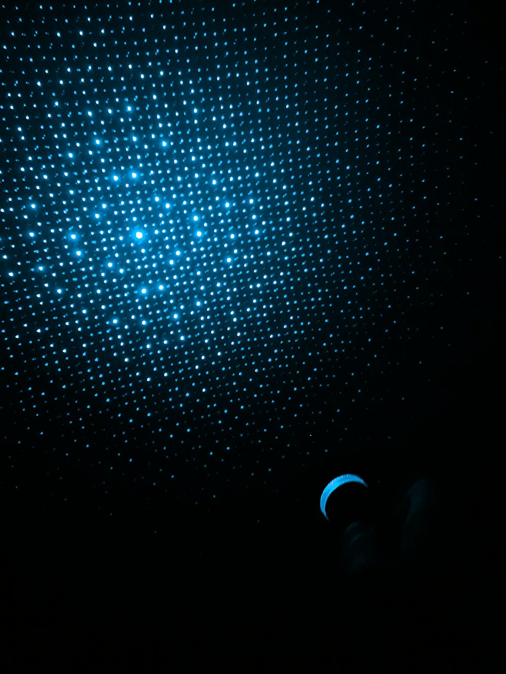 a black background with a blue dot pattern