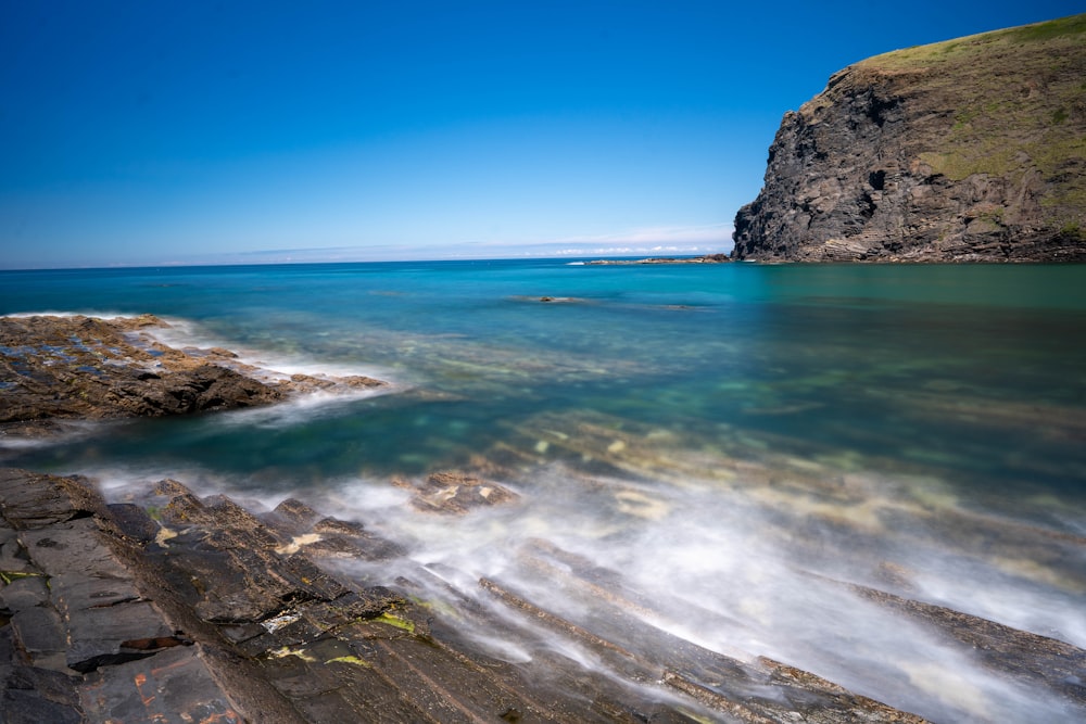 body of water under clear blue sky during daytime