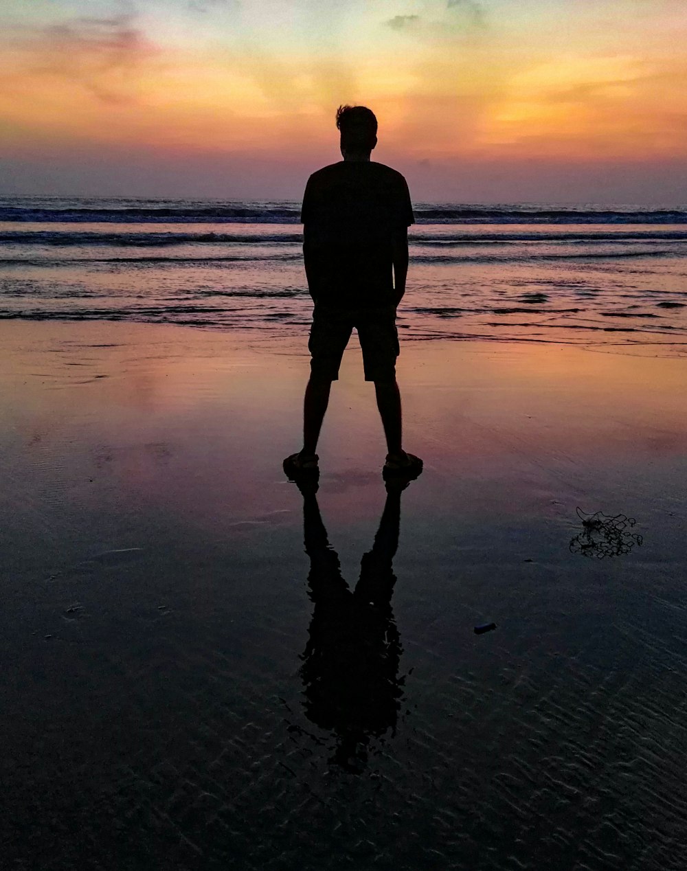 man standing on shore at night