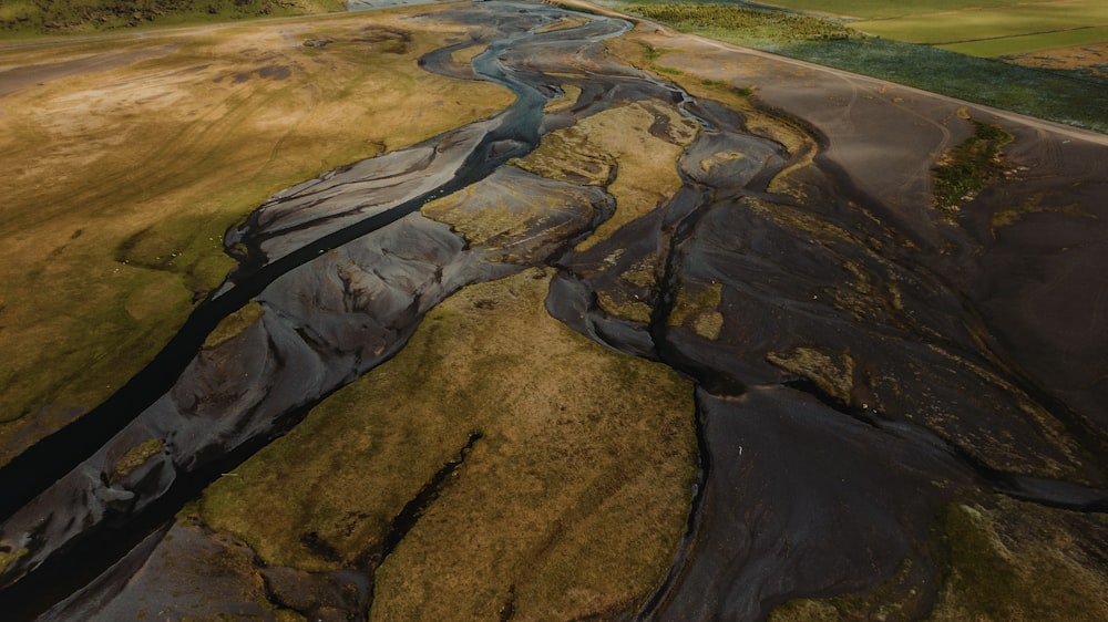 an aerial view of a river running through a field