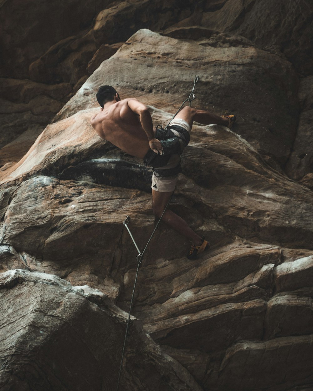 man climbing on rocky mountain