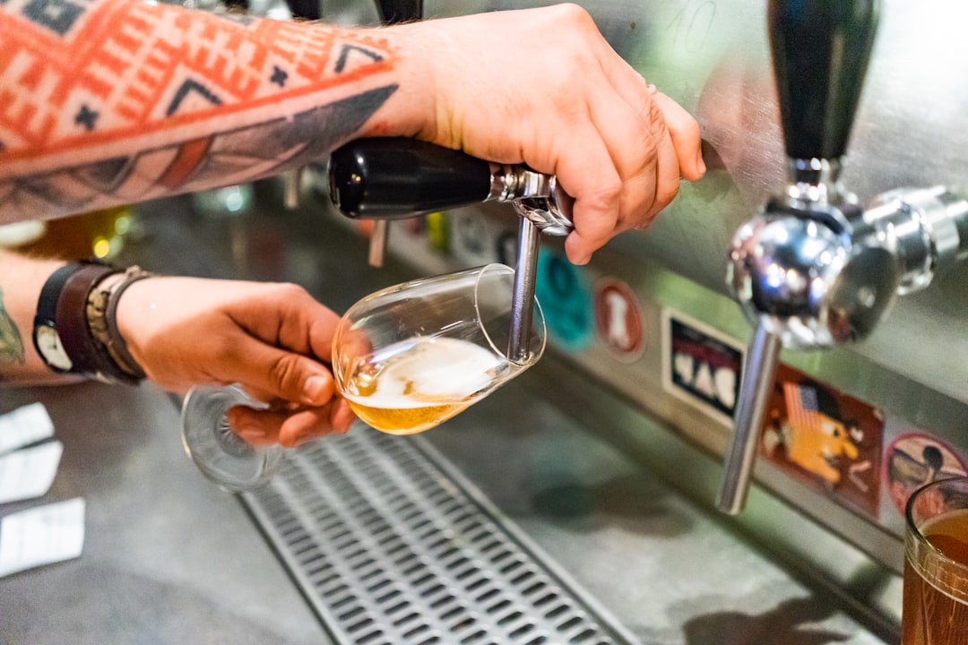 woman putting beer to the wine glass