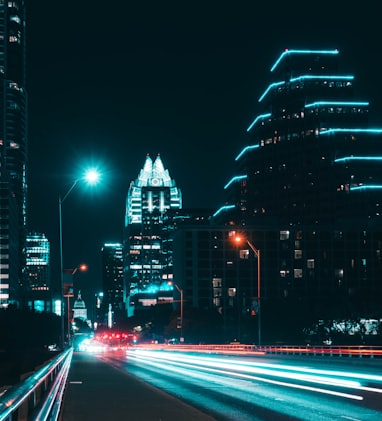 lighted street and high-rise buildings