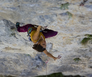 time-lapse photography of woman rock climbing
