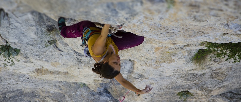 time-lapse photography of woman rock climbing
