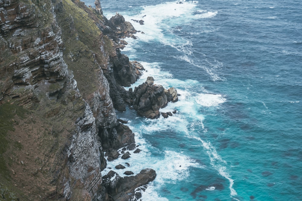 aerial photography of waves splashing on rocks