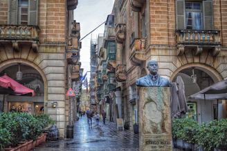 A vibrant street scene in Malta with traditional buildings and a vendor selling pastizzi, capturing the local charm.