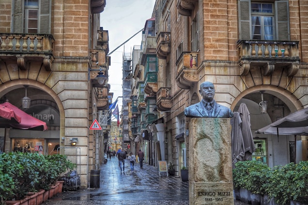 A vibrant collage showing diverse Maltese cityscapes with people engaging in various local businesses and services.