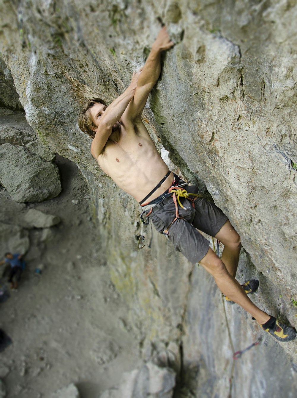 a man climbing up the side of a mountain