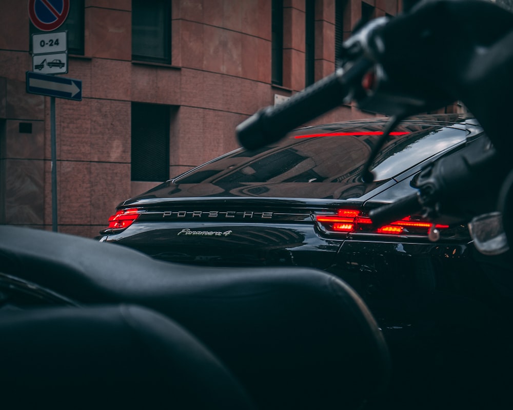 black vehicle beside motorcycle during daytime