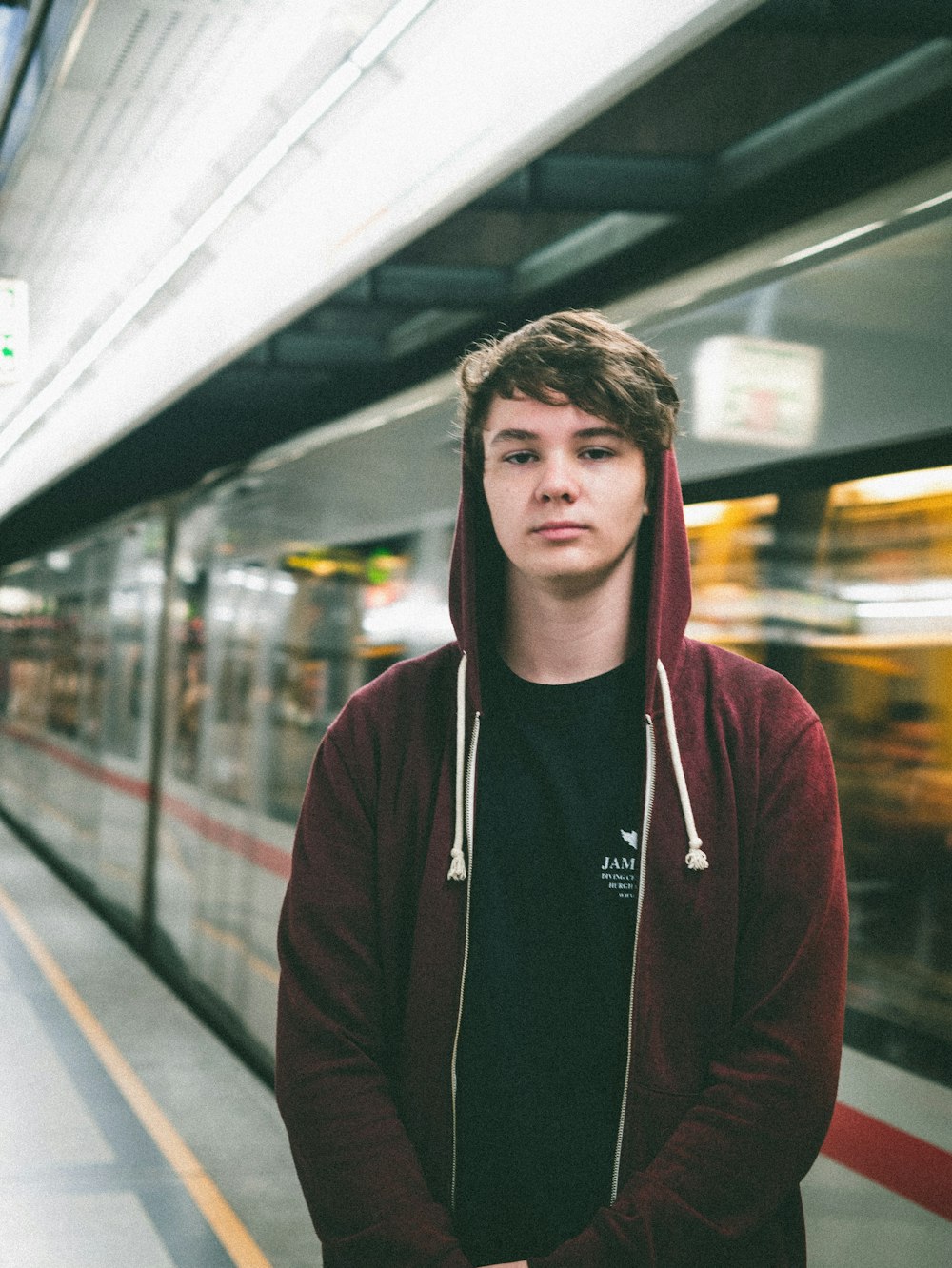 man standing beside a running train