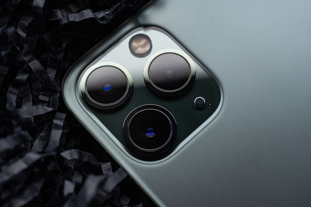 a close up of a cell phone with three cameras