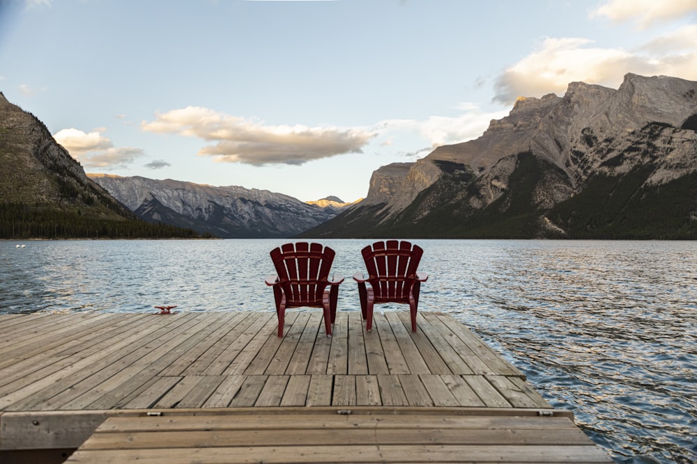 two red chairs on dock