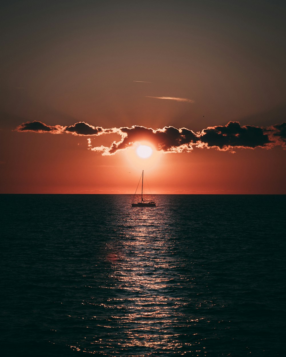 sailboat in sea during golden hour