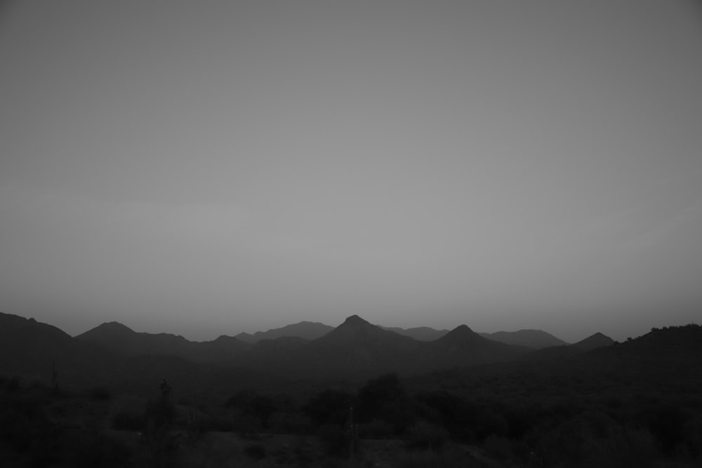 silhouette of mountains under cloudy sky