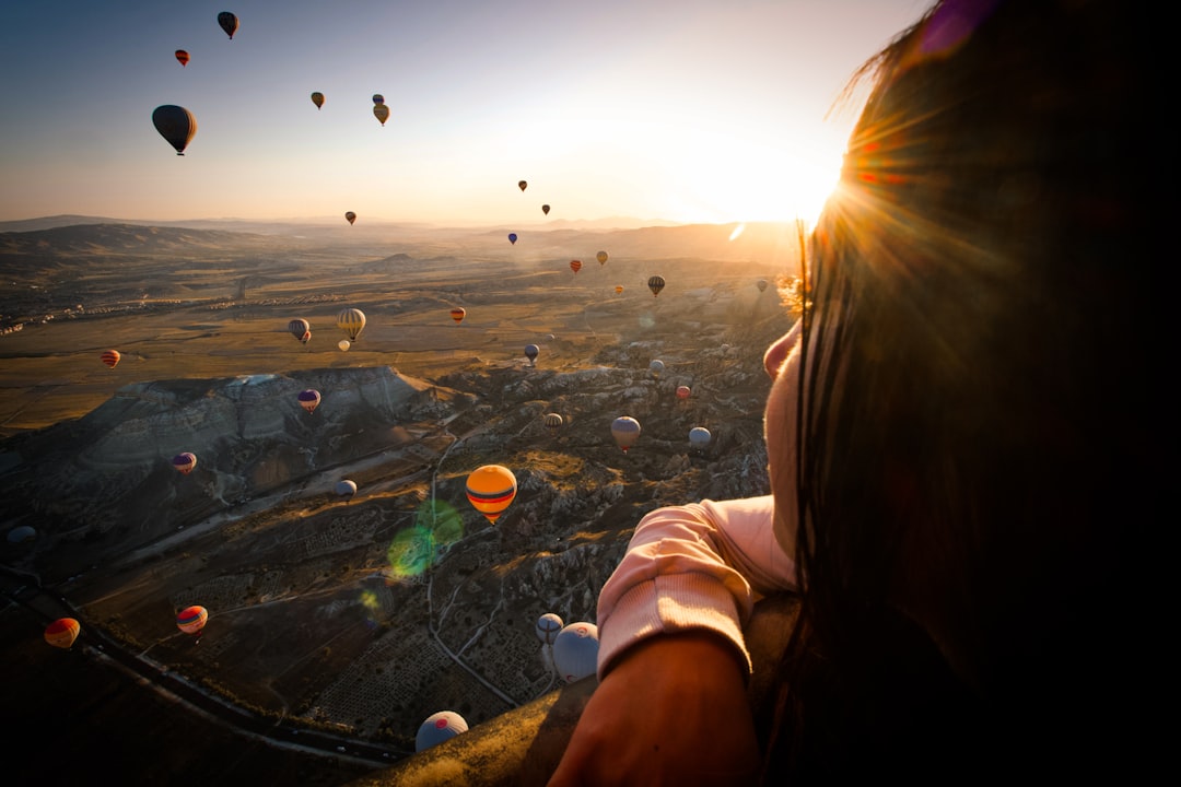 hot air balloons above woman, fly...
