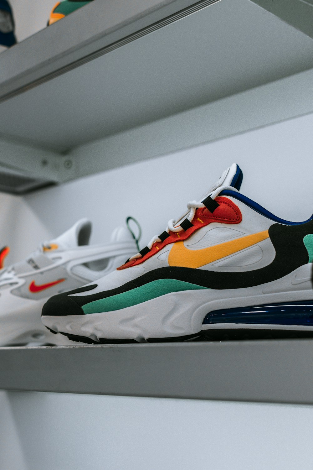 white and multicolored Nike Air Max shoe on shelf