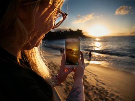 woman taking picture of beach