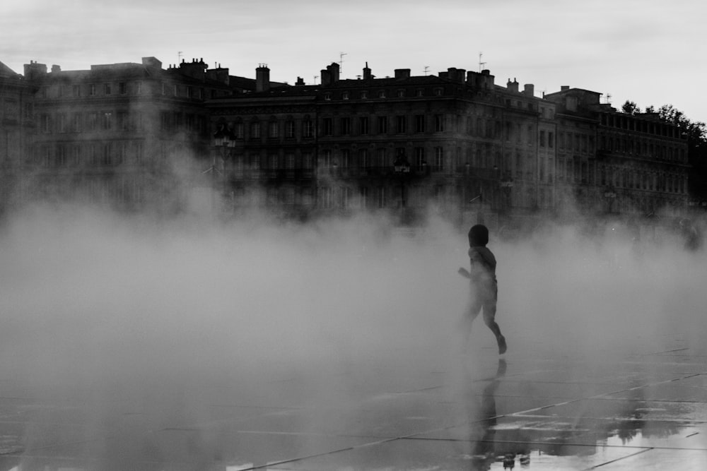 person walking in fog