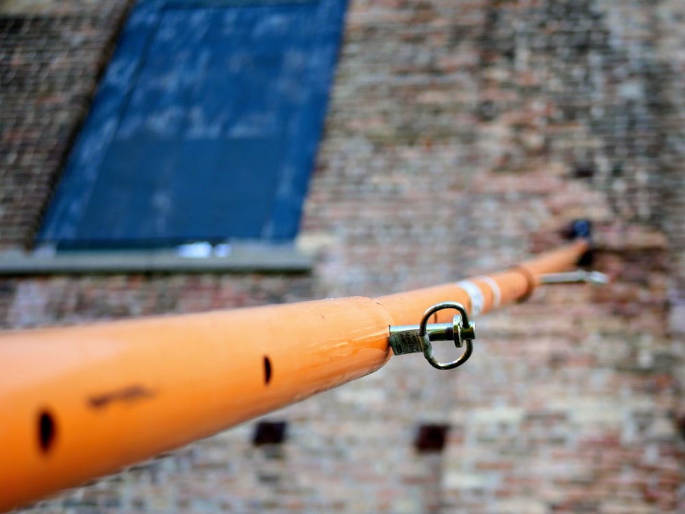 orange pole on building wall