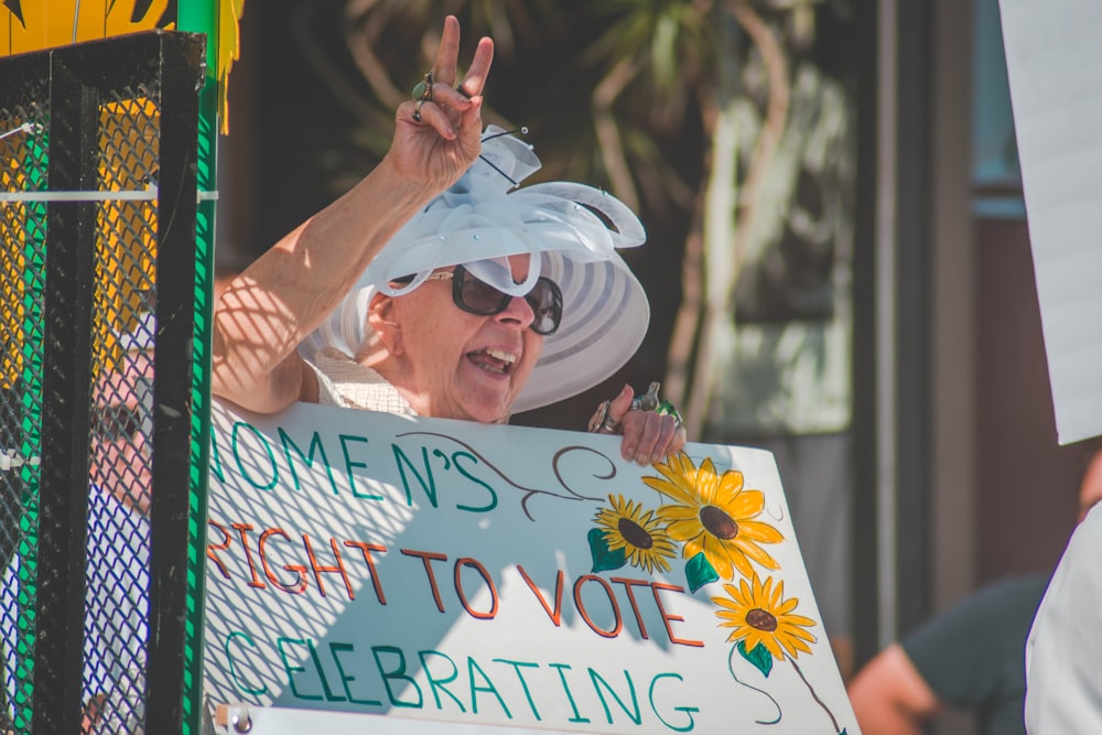 woman holding women's right to vote celebrating banner