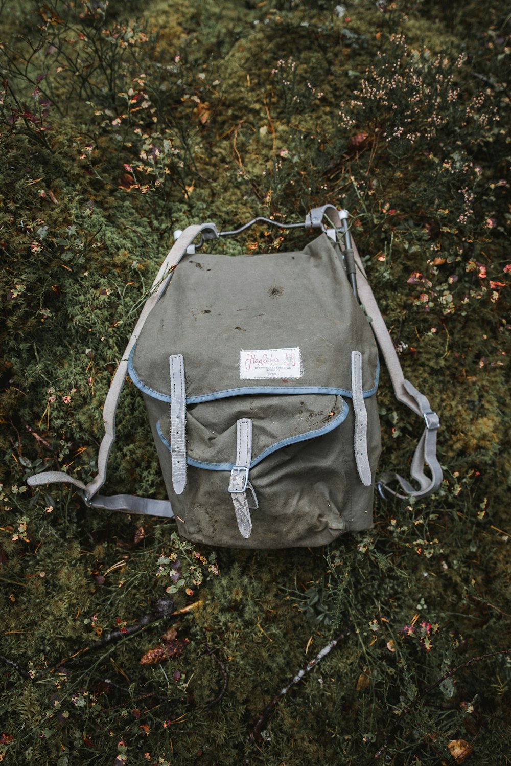 grey and blue backpack on the grass field
