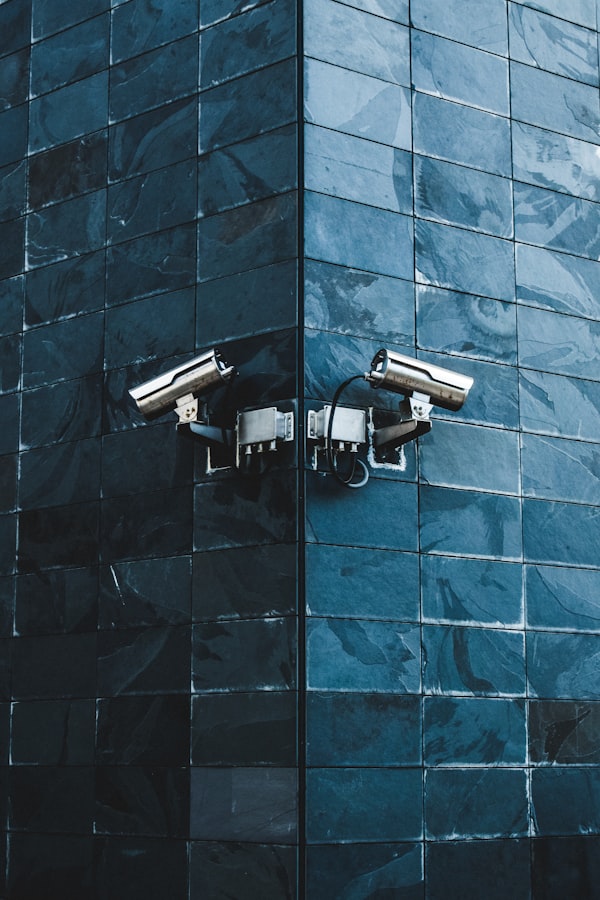 Close view of a security camera on a dark wall