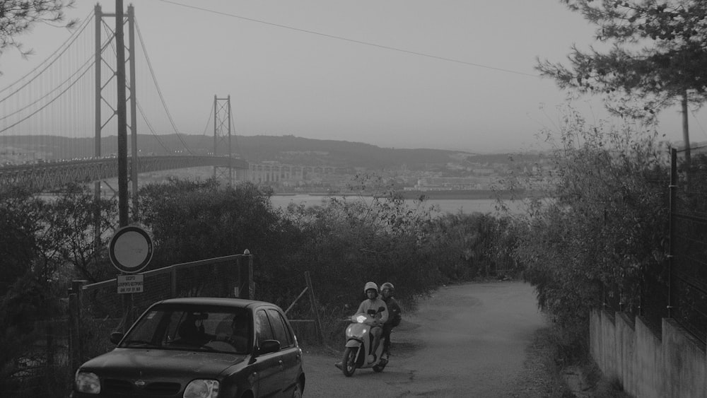 grayscale photo of men riding on motorcycle