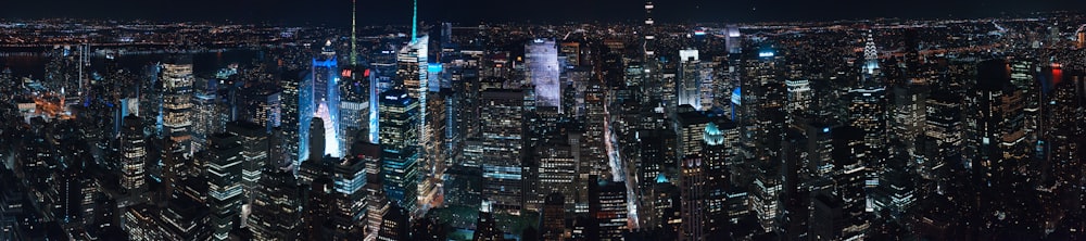 aerial photography of city with high-rise buildings during night time