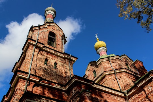 brown church photo in Kuldīga Latvia