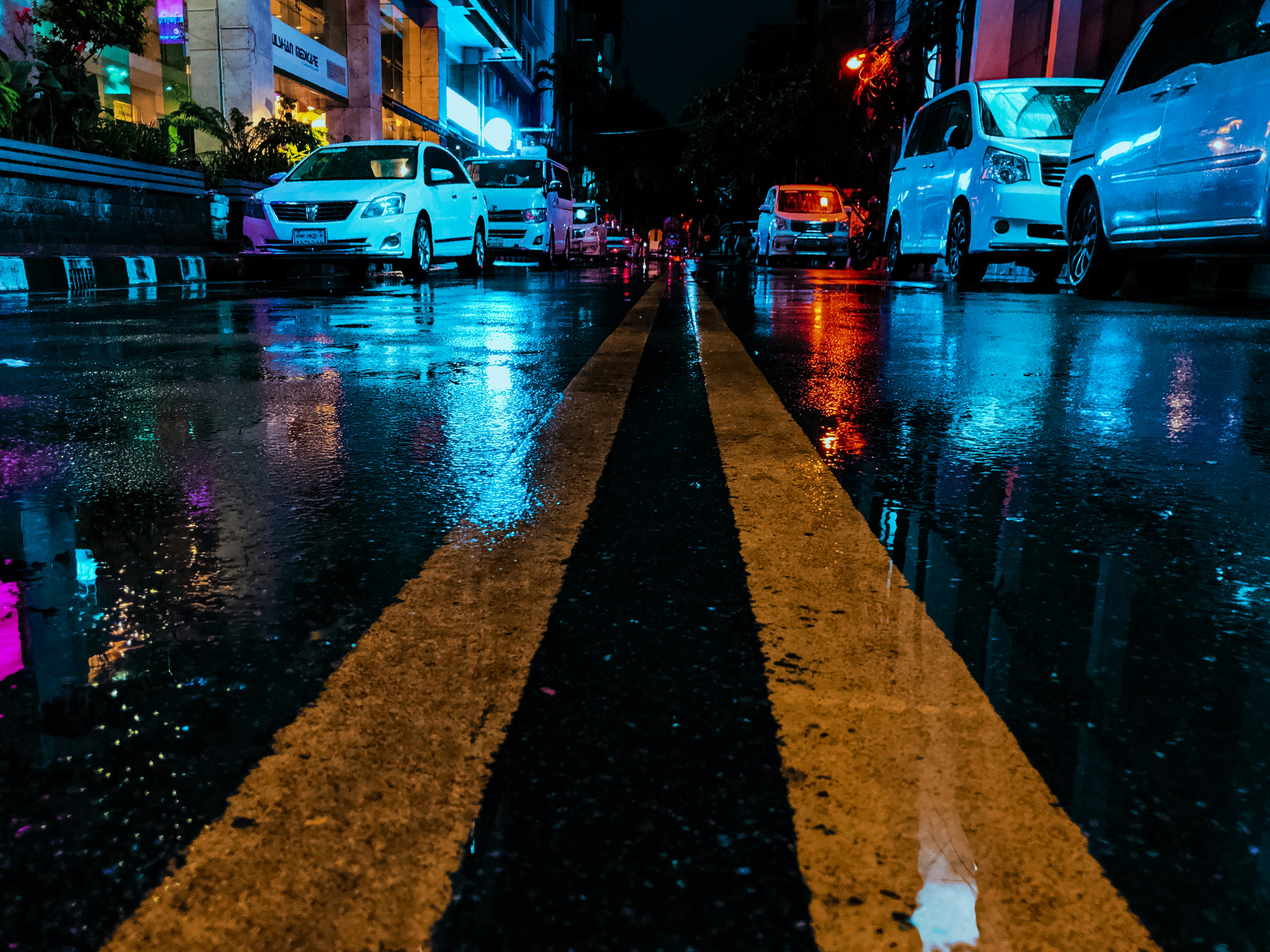 white sedan on road during nighttime