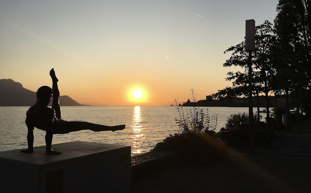 silhouette of man doing fitness activity sunset scenery