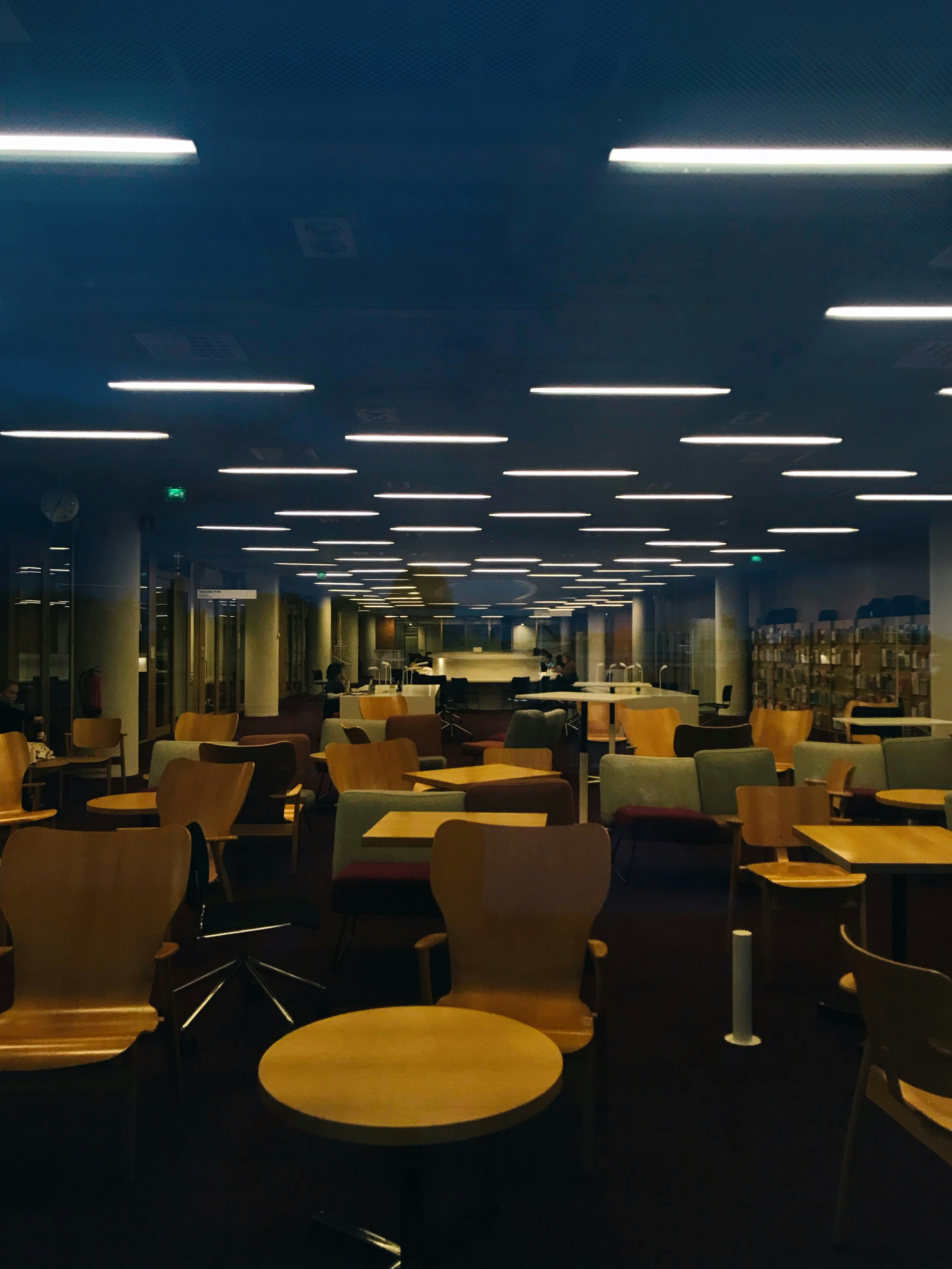 Tables and chairs on dimmed room photo Free Grey Image