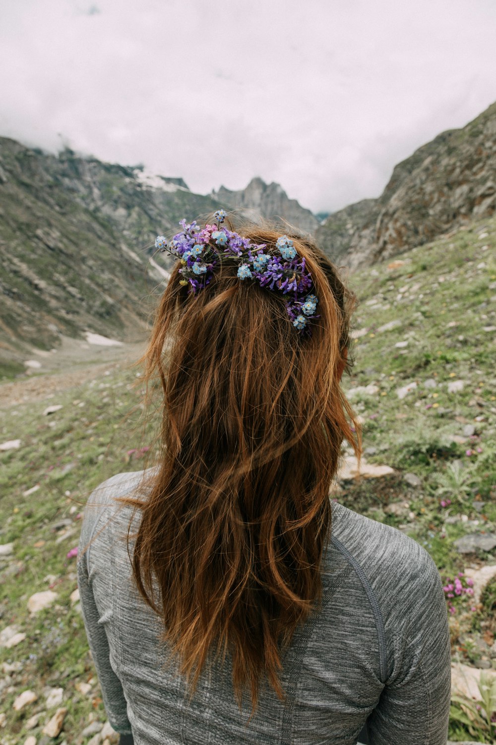 back view of woman with purple floral hairpiece