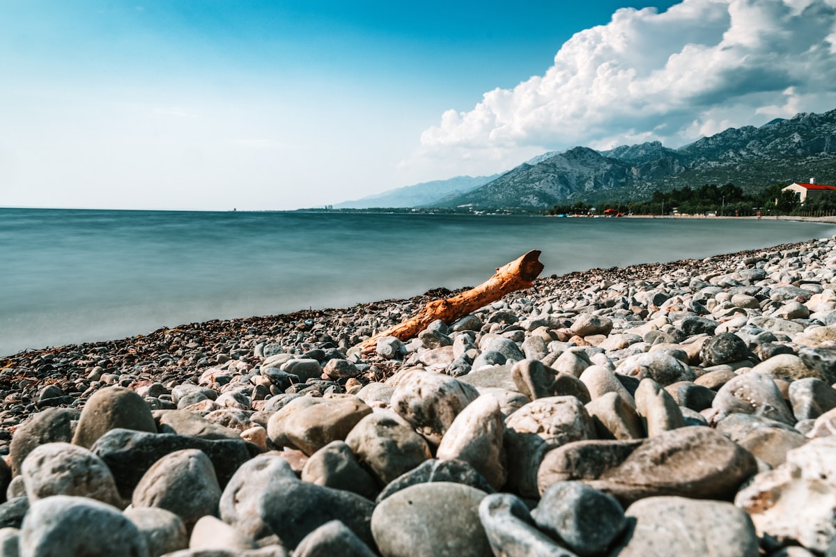 A pebble seashore on the Adriatic coast near Split, Croatia, with clear shallow water