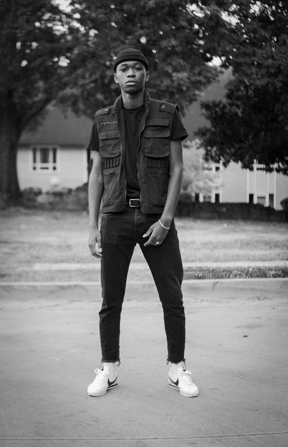 grayscale photography of man wearing brown vest