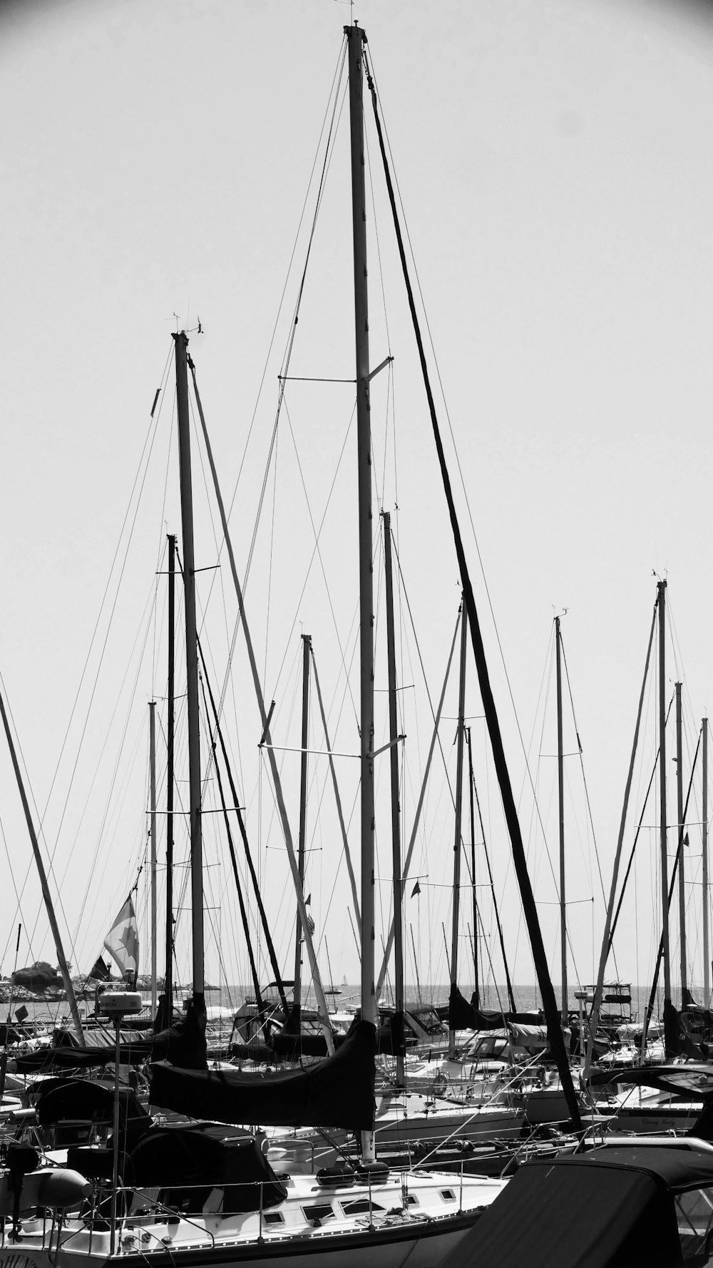 yachts at the harbor in grayscale photo