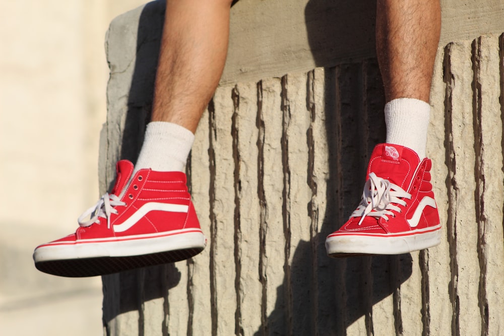 person wearing red Vans high-top sneakers