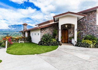 green grass field and brown wooden door