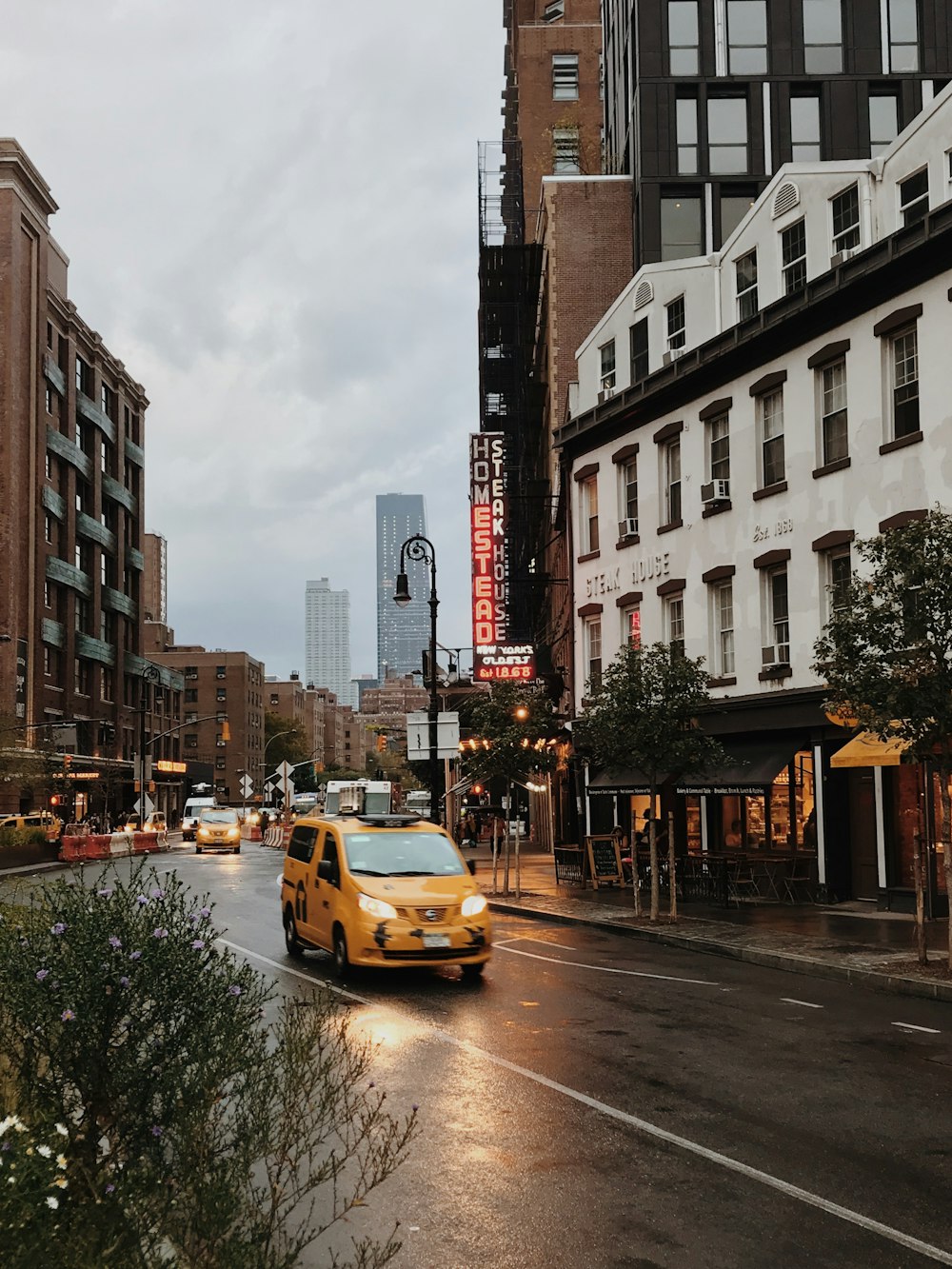 yellow taxi near buildings