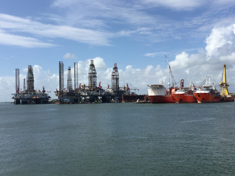 orange ship and gray oil rig