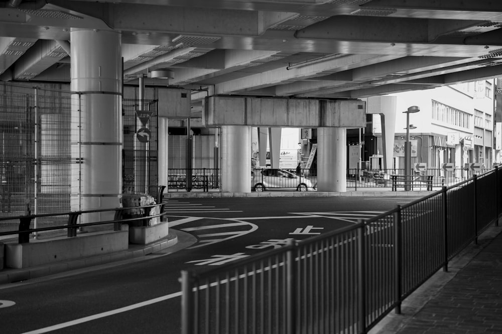 grayscale photography of railings and road