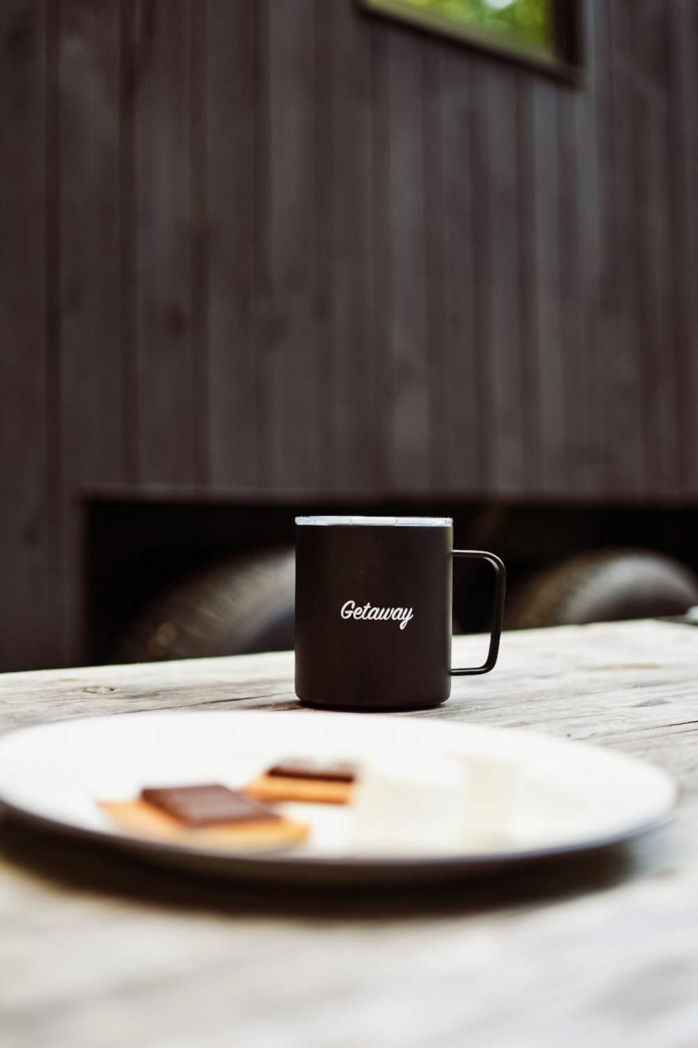 black mug beside plate