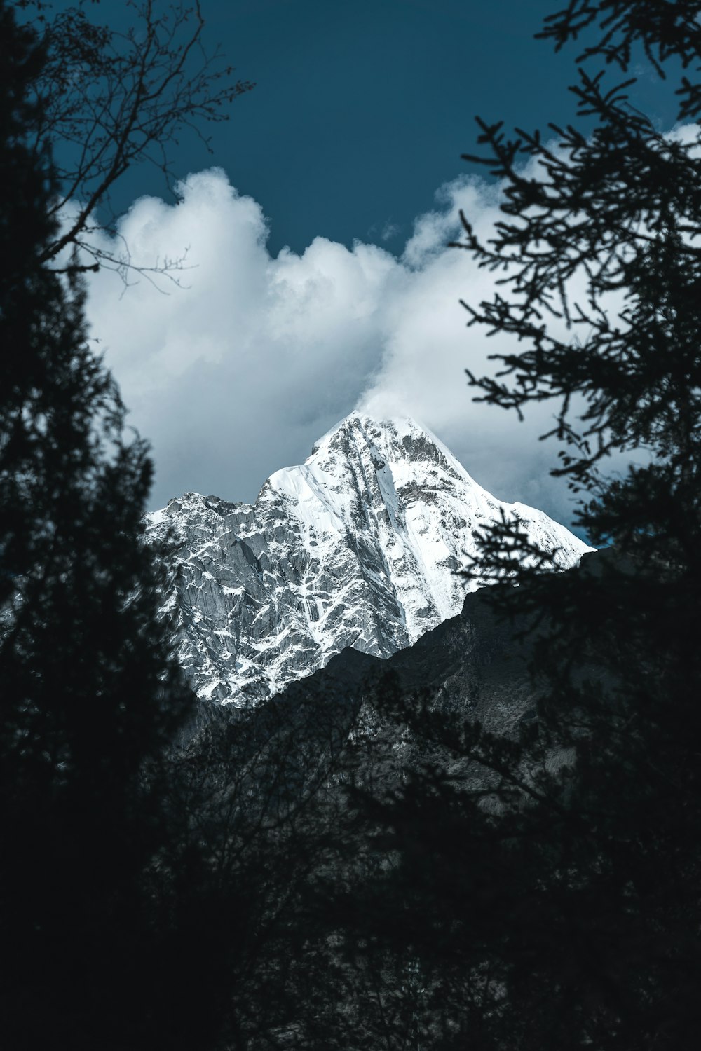 white mountain across white clouds