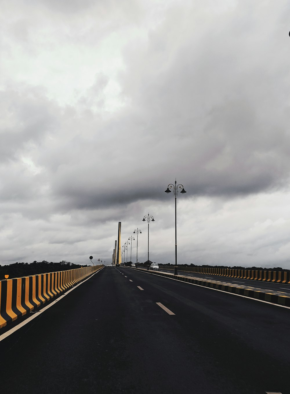 grey light posts beside road